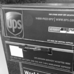 Black and white photo of a UPS drop off box