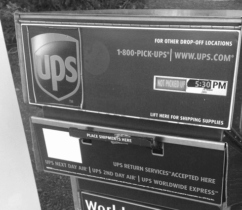 Black and white photo of a UPS drop off box