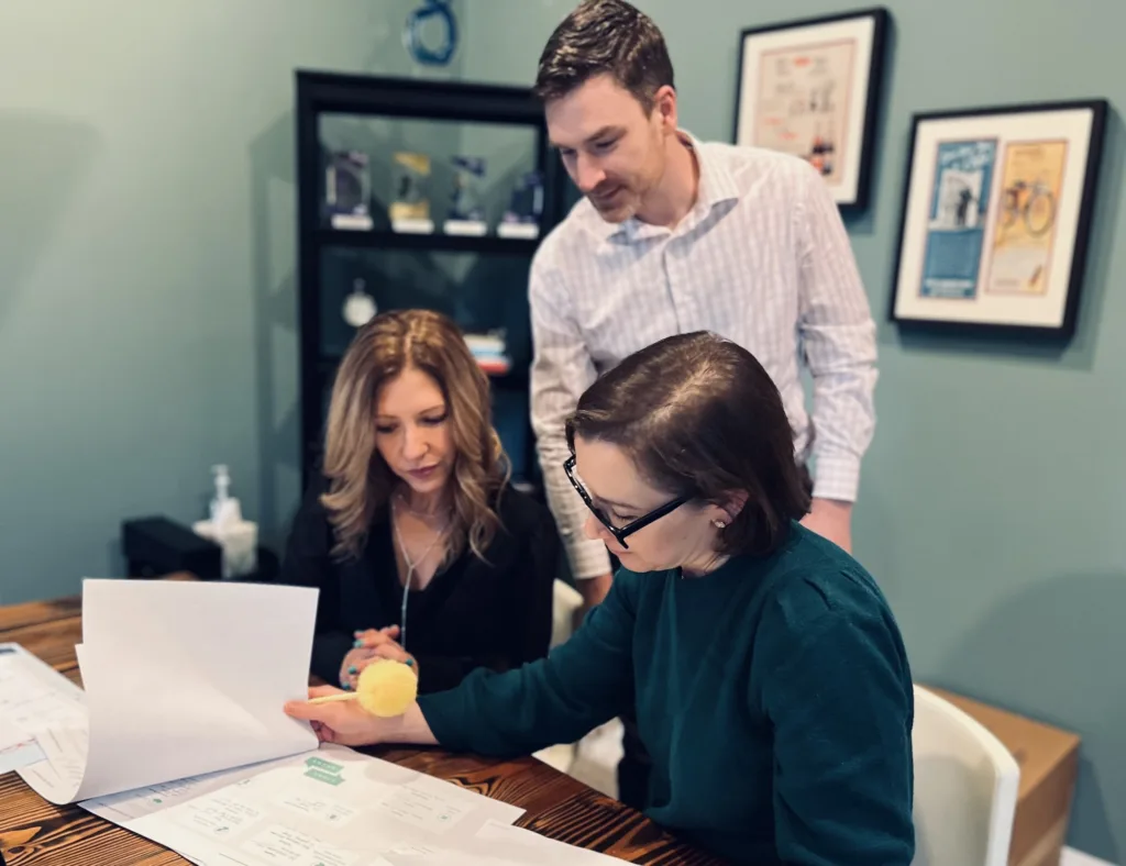 Heather Reddy and the FatRabbit Creative team review a StoryBrand Script at the office